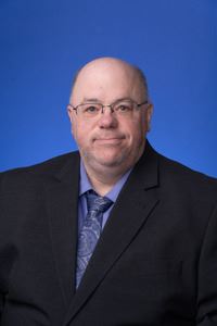 Jon Martz (headshot on a blue background)